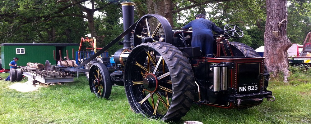 Steam engine running a wood saw on rally day